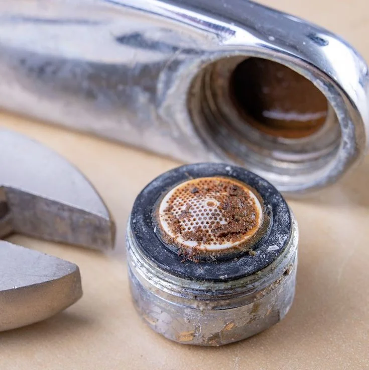 Corroded faucet with mineral buildup undergoing faucet repair