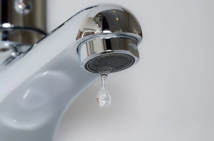 Dripping kitchen faucet awaiting faucet repair to stop water waste