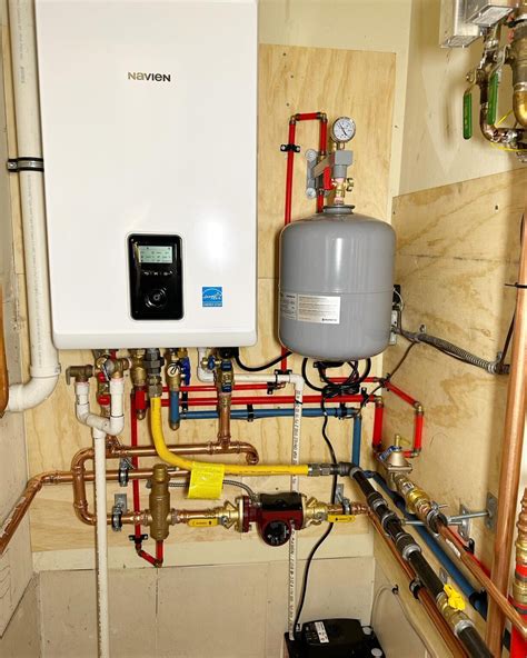 Modern tankless Water Heater Installation mounted on a laundry room wall