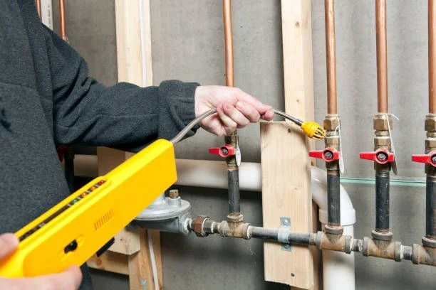 Plumber providing gas line services during a kitchen gas line installation