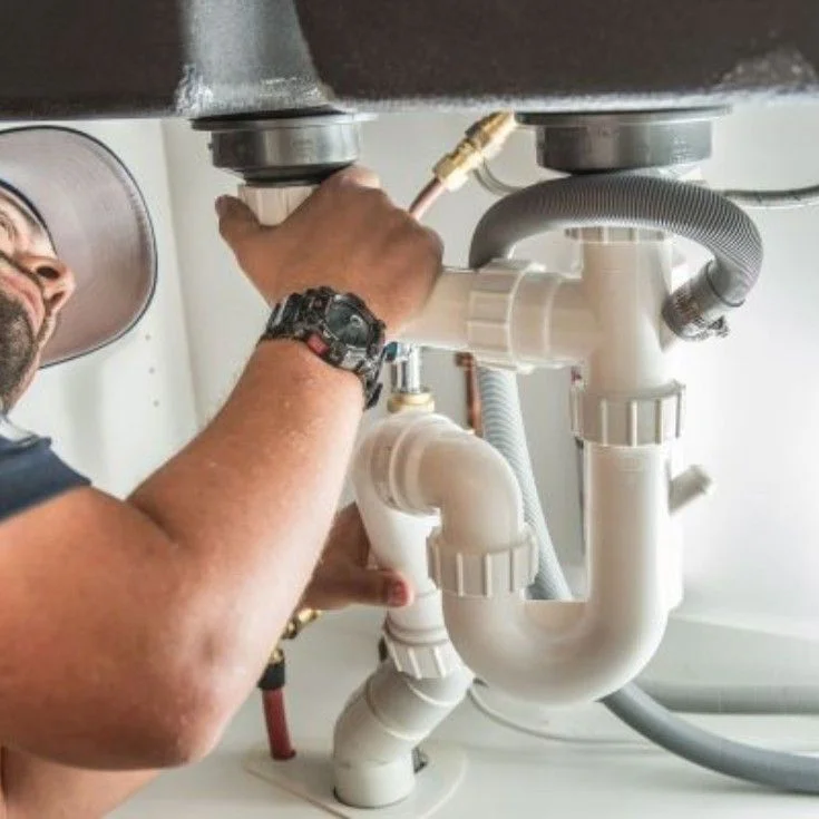 Technician fixing broken pipes
