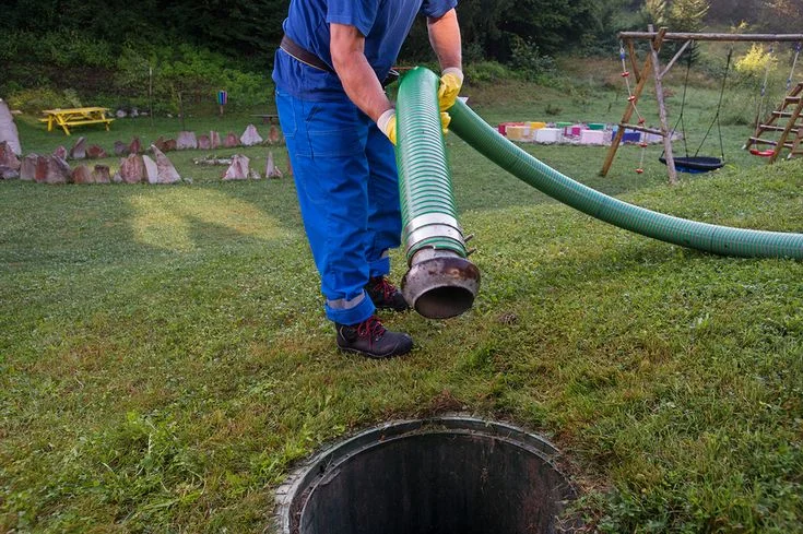 drain field receiving septic system services showing a well-maintained grassy area with an inspection cover