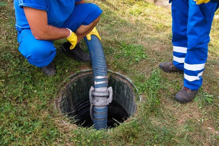 performing septic system services with professional pumping equipment and a service truck