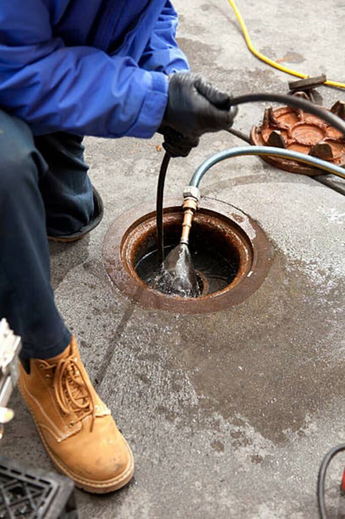 technician performing sewer and drain work