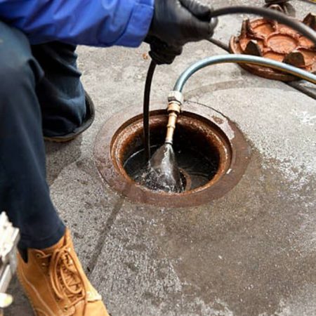 technician performing sewer and drain work